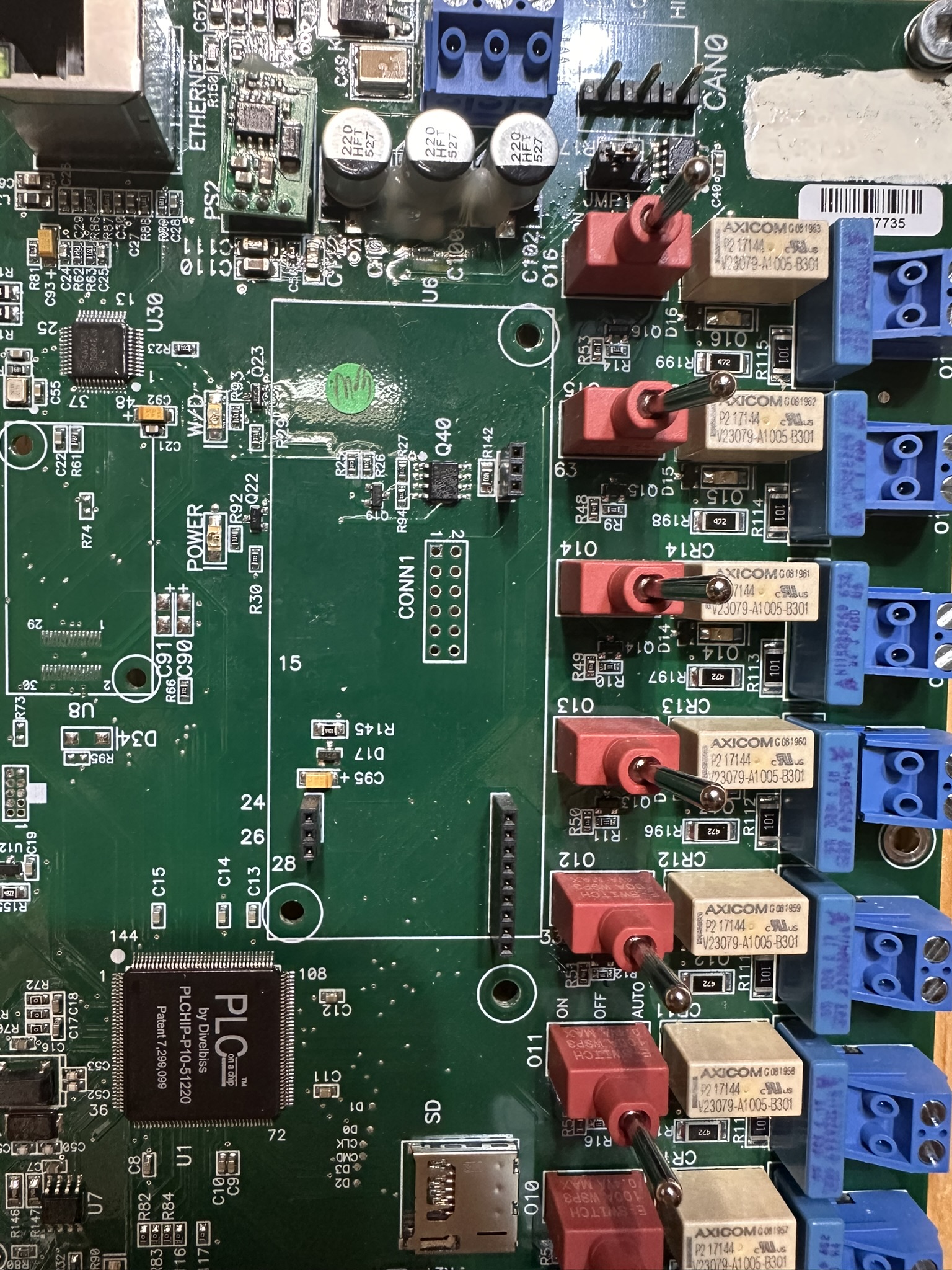 Industrial electronic control board with components and wiring connectors on a repair bench